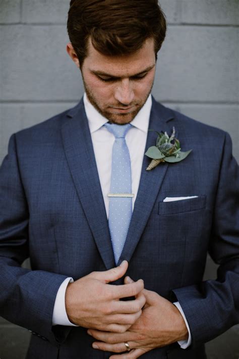 navy suit with light blue tie